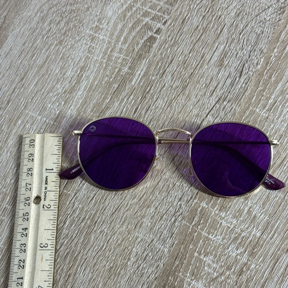 Rainbow OPTX Round sunglasses a gold metal frame and indigo purple lenses